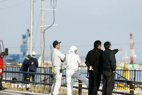 Lực lượng chức năng kiểm tra mực nước tại một bến cảng sau cảnh báo sóng thần do động đất ở Soma, tỉnh Fukushima ngày 22/11. 
