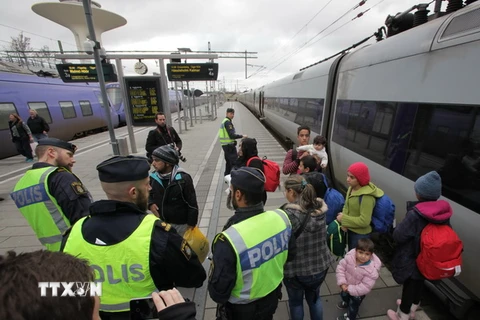 Cảnh sát kiểm tra nhóm người nhập cư tại sân ga ở Malmo ngày 12/11. (Nguồn: AFP/TTXVN)