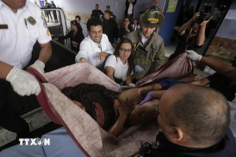 Chuyển em nhỏ bị thương trong vụ hỏa hoạn ở trung tâm tới bệnh viện San Juan de Dios ở Guatemala City ngày 8/3. (Nguồn: AFP/TTXVN) 