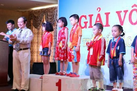 Phó Chủ tịch Liên đoàn cờ Việt Nam Đặng Tất Thắng trao huy chương cho các vận động viên đoạt huy chương nội dung cờ tiêu chuẩn lứa tuổi 7. (Ảnh: Trần Thị Thu Hiền/TTXVN)