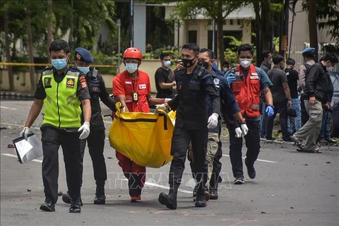 Cảnh sát chuyển thi thể nghi phạm tại hiện trường vụ đánh bom liều chết bên ngoài nhà thờ ở Makassar, Indonesia, ngày 28/3/2021. (Ảnh: AFP/TTXVN)