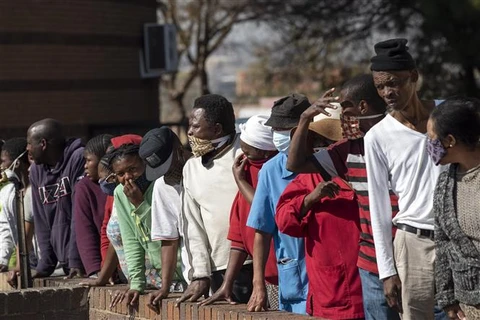 Người dân xếp hàng chờ nhận thực phẩm và hàng hóa cứu trợ tại Johannesburg, Nam Phi, ngày 5/6/2020 trong bối cảnh dịch COVID-19 lan rộng. (Ảnh: THX/TTXVN)