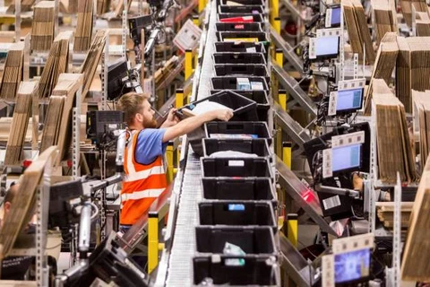 Một công nhân sắp xếp các hộp chứa đơn hàng tại một trung tâm của Amazon tại Italy. (Nguồn: ft.com)