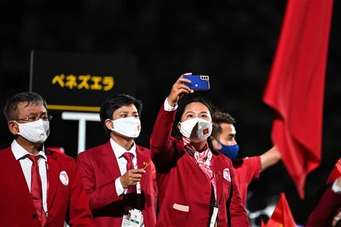 Đoàn thể thao Việt Nam diễu hành tại Lễ khai mạc Paralympic Tokyo 2020 ở Tokyo (Nhật Bản), ngày 24/8/2021. (Ảnh: AFP/ TTXVN)