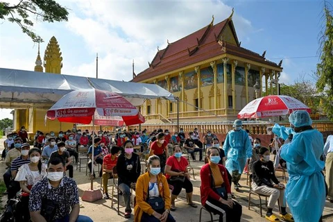 Người dân chờ tiêm vaccine ngừa COVID-19 tại Phnom Penh (Campuchia). (Ảnh: AFP/TTXVN)