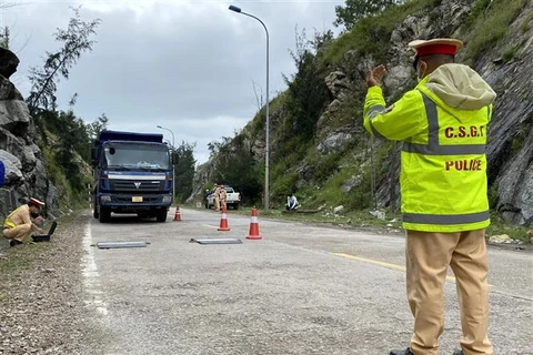 Cân tải trọng xe tải chở nguyên vật liệu tại Quốc lộ 24C, xã Bình Thuận, huyện Bình Sơn (Quảng Ngãi). (Ảnh: Lê Ngọc Phước/TTXVN)