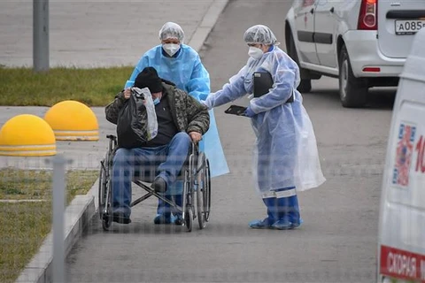 Chuyển bệnh nhân nhiễm COVID-19 tới bệnh viện ở ngoại ô Moskva (Nga). (Ảnh: AFP/TTXVN)