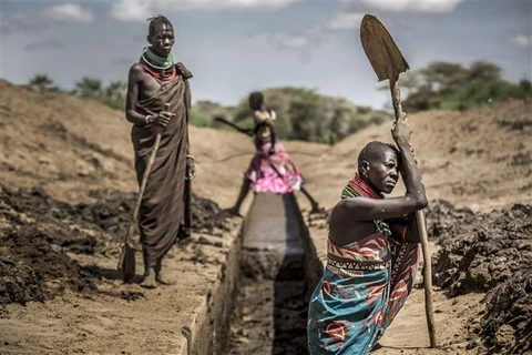 Người dân khơi thông một con kênh lấy nước ở Nanyee (Kenya). (Ảnh: AFP/TTXVN)
