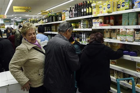 Người dân mua hàng tại siêu thị ở Madrid (Tây Ban Nha). (Ảnh: AFP/TTXVN)