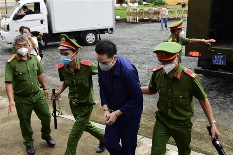 Dẫn giải bị cáo Nguyễn Kim Trung Thái tới Toà. Ảnh: Thanh Vũ - TTXVN