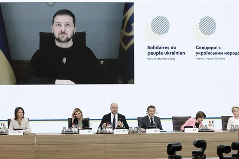 Tổng thống Ukraine Volodymyr Zelensky (góc trái, trên màn hình) phát biểu qua video tại Hội nghị quốc tế về viện trợ khẩn cấp cho Ukraine, do Pháp tổ chức hôm 13/12/2022. (Ảnh: AFPTTXVN)