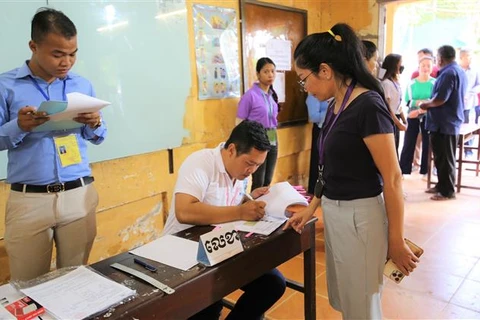 Cử tri Saroeun Sopor (43 tuổi) thực hiện thủ tục bỏ phiếu theo quy định tại phòng bầu cử số 2080, Trường Trung học Phổ thông Chea Sim Chroy Changvar, quận Chroy Changvar, Thủ đô Phnom Penh sáng 23/7/2023. (Ảnh: Hoàng Minh/TTXVN)