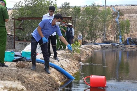 Lực lượng chức năng của thị xã Phú Mỹ và tỉnh Bà Rịa-Vũng Tàu lấy mẫu kiểm tra khu vực xả thải của Công ty Trách nhiệm Hữu hạn Kbec Vina vào thời điểm tháng 5/2023. (Ảnh: TTXVN phát)