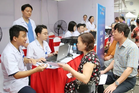 Các bác sỹ Hội Thầy thuốc Trẻ Việt Nam khám chữa bệnh miễn phí cho người dân. (Ảnh: Minh Đức/TTXVN)