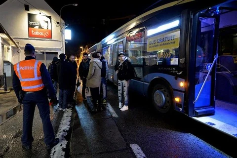 Cảnh sát Bỉ đứng kiểm soát hành khách đi xe buýt từ Pháp đến Bỉ ở Adinkerke, ngày 23/2. (Nguồn: AFP)