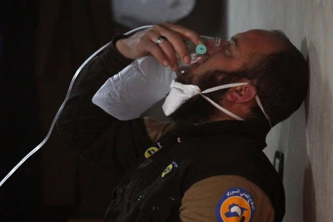 Một nhân viên dân phòng Syria phải đeo mặt nạ thở ôxy sau khi cứu hộ ở Khan Sheikhoun, Idlib, Syria, ngày 4/4. (Nguồn: Reuters)