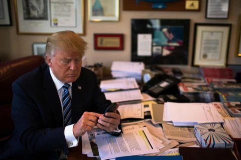 Tổng thống Mỹ Donald Trump sử dụng điện thoại trong phòng làm việc. (Nguồn: Reuters)