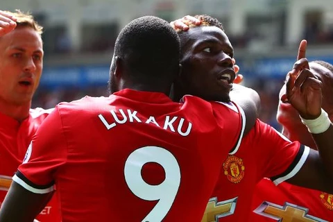 Paul Pogba (phải) ăn mừng cùng với đồng đội Romelu Lukaku (trái) sau khi ghi bàn thắng trong trận đấu với Swansea City. (Nguồn: AFP)