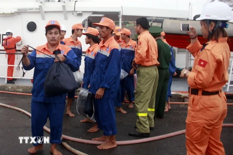 Thuyền viên tàu cá BĐ 98079 TS được đưa vào bờ an toàn. (Ảnh: Phan Sáu/TTXVN)
