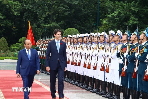 Thủ tướng Nguyễn Xuân Phúc và Thủ tướng Canada Justin Trudeau duyệt Đội danh dự Quân đội Nhân dân Việt Nam. (Ảnh: Thống Nhất/TTXVN)
