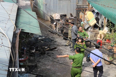 Lực lượng công an tiếp cận hiện trường vụ cháy tại khu nhà số 13 Trần Hưng Đạo khiến 5 người thiệt mạng trong tối 12/3. (Ảnh: Nguyễn Dũng/TTXVN)