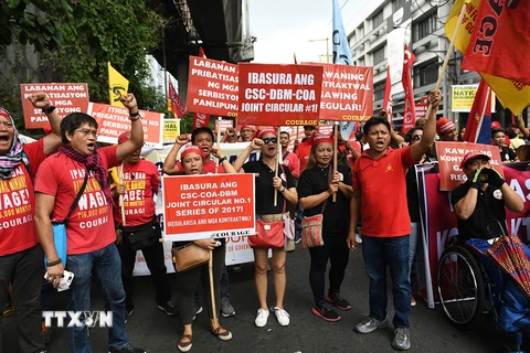 Người dân tham gia tuần hành yêu cầu Chính phủ sửa đổi chính sách lao động tại Manila, Philippines ngày 1/5. (Nguồn: AFP/TTXVN)