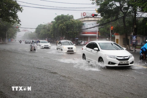 Mưa lớn khiến tuyến phố Phan Đình Phùng (Hà Tĩnh) bị ngập sâu, gây khó khăn cho các phương tiện khi lưu thông trên tuyến phố này. (Ảnh: Phan Quân/TTXVN)