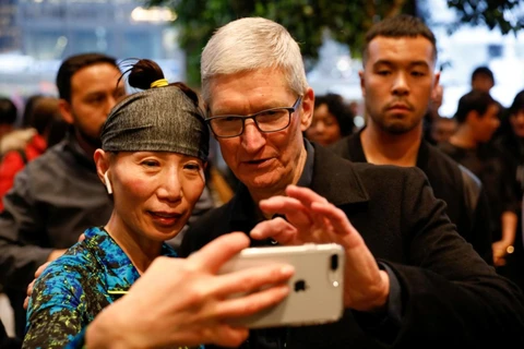 Giám đốc điều hành của Apple Tim Cook chụp ảnh với một khách hàng ở cửa hàng Apple Store ở Chicago, Illinois. (Nguồn: Reuters)
