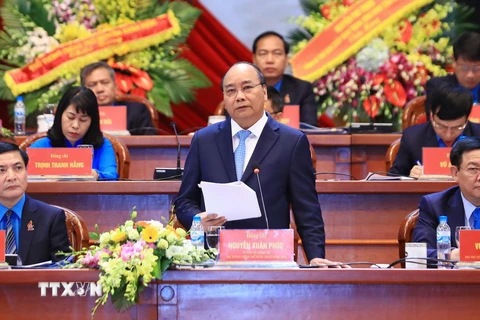 Thủ tướng Nguyễn Xuân Phúc phát biểu tại Diễn đàn: "Công đoàn Việt Nam đồng hành cùng Chính phủ nâng cao năng lực cạnh tranh quốc gia và phát triển bền vững đất nước.” (Ảnh: Thống Nhất/TTXVN