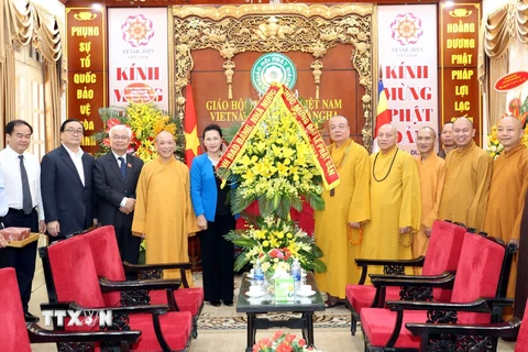 Chủ tịch Quốc hội Nguyễn Thị Kim Ngân tặng hoa cho Hòa thượng Thích Thanh Nhiễu và Giáo hội Phật giáo Việt Nam. (Ảnh: Trọng Đức/TTXVN)