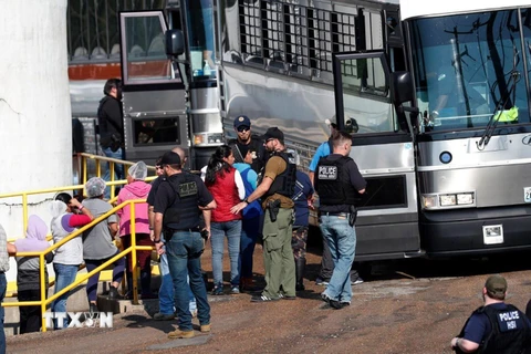 Lực lượng chức năng Mỹ bắt giữ người di cư bất hợp pháp làm việc tại nhà máy Koch Foods Inc. ở Morton, bang Mississippi ngày 8/8/2019. (Nguồn: AP/TTXVN)