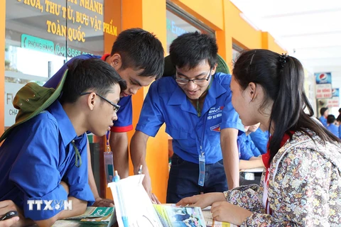 Thanh niên tình nguyện hướng dẫn, tư vấn cho các thí sinh tại bến xe Giáp Bát. (Ảnh: Dương Giang/TTXVN)