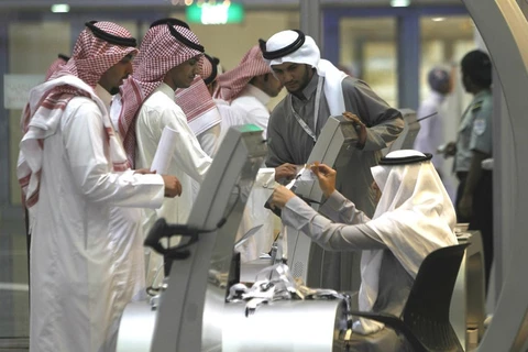 Người tìm việc xếp hàng nói chuyện với một nhà tuyển dụng tại một gian hàng tại hội chợ việc làm ở Riyadh. (Nguồn: Reuters)