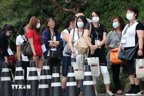  Khách du lịch tại thủ đô Seoul, Hàn Quốc đeo khẩu trang để phòng tránh lây nhiễm MERS ngày 13/6. (Nguồn: Yonhap/TTXVN)