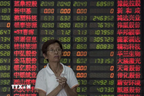 Nhà đầu tư theo dõi tỉ giá chứng khoán tại thủ đô Bắc Kinh, Trung Quốc ngày 1/9. (Nguồn: AFP/TTXVN)