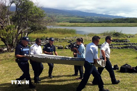 Chuyển mảnh vỡ máy bay được nghi là của MH370 trên đảo Reunion ngày 29/7. (Nguồn: AFP/TTXVN)