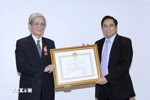 Ông Phạm Minh Chính, Ủy viên Bộ Chính trị, Bí thư Trung ương Đảng, Trưởng Ban tổ chức Trung ương trao tặng Huân chương Độc lập hạng Nhất cho ông Hồ Tiến Nghị. (Ảnh: An Đăng/TTXVN)