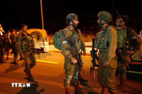 Binh sỹ Israel gác tại hiện trường một vụ đâm xe tại Khu Bờ Tây. (Nguồn: AFP/TTXVN)