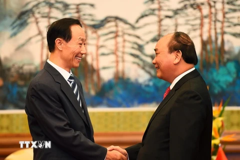 Thủ tướng Chính phủ Nguyễn Xuân Phúc tiếp Phó Chủ tịch Chính hiệp toàn quốc Trung Quốc Vương Gia Thụy. (Ảnh: Thống Nhất/TTXVN)