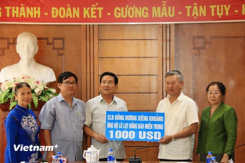 Đại sứ Nguyễn Mạnh Hùng đang tiếp nhận số tiền tượng trưng từ Đại diện câu lạc bộ Đồng hương Xi​eng Kho​ang. (Ảnh: Phạm Kiên/Vietnam+)