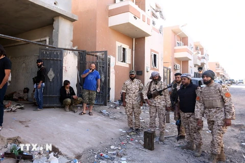  Lực lượng trung thành với Chính phủ Đoàn kết dân tộc Libya gác tại một trạm kiểm soát ở thành phố Sirte ngày 20/11. (Nguồn: THX/TTXVN)