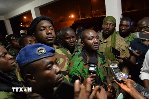 Phát ngôn viên của nhóm binh sỹ tiến hành binh biến Issiaka Ouattara (giữa) trả lời phỏng vấn báo chí sau cuộc đàm phán với Bộ trưởng Quốc phòng Alain Richard Donwahi tại Bouake ngày 7/1. (Nguồn: AFP/TTXVN)