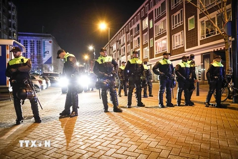 Cảnh sát gác tại một con phố khi người Thổ Nhĩ Kỳ tại Hà Lan biểu tình bên ngoài lãnh sự quán Thổ Nhĩ kỳ ở Rotterdam đòi gặp bà Fatma Betul Sayan Kaya, người đã bị cảnh sát ngăn cản tới thành phố này, ngày 11/3. (Nguồn: EPA/TTXVN)