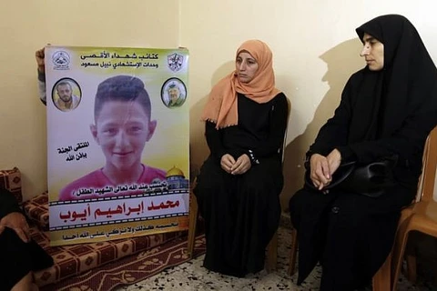 Mẹ của Mohammed Ayoub bên bức ảnh con mình. (Nguồn: timesofisrael.com)