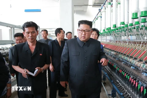 Nhà lãnh đạo Triều Tiên (phải) thăm nhà máy dệt ở Sinuiju ngày 2/7. (Nguồn: Yonhap/TTXVN)