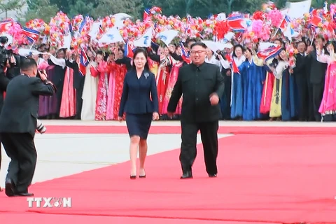 Nhà lãnh đạo Triều Tiên Kim Jong-un (phải, phía trước) và phu nhân Ri Sol-ju (trái, phía trước) đón Tổng thống Hàn Quốc Moon Jae-in tại sân bay Sunan. (Ảnh: Yonhap/TTXVN)