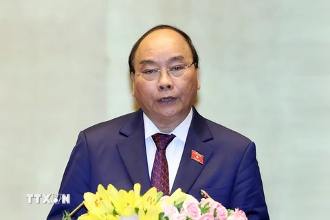 Thủ tướng Chính phủ Nguyễn Xuân Phúc trình bày Báo cáo về tình hình kinh tế-xã hội năm 2018 và kế hoạch phát triển kinh tế-xã hội năm 2019. (Ảnh: Thống Nhất/TTXVN)