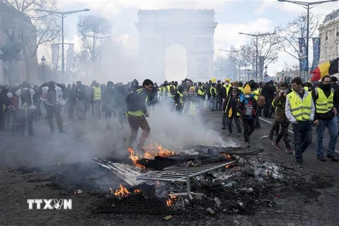 Người biểu tình 'Áo vàng' đốt các rào chắn trên đại lộ Champs-Elysees tại thủ đô Paris, Pháp, ngày 16/3/2019. (Ảnh: THX/ TTXVN)