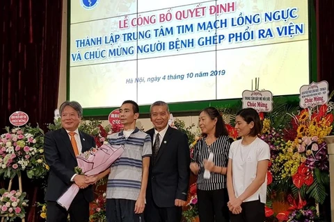 Các bác sỹ tặng hoa chúc mừng bệnh nhân ghép phổi đầu tiên được xuất viện. (Ảnh: PV/Vietnam+)