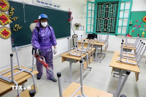 Trường THCS Trưng Vương, quận Hoàn Kiếm tiến hành phun thuốc khử khuẩn trong sáng ngày 14/2. (Ảnh: Thanh Tùng/TTXVN)